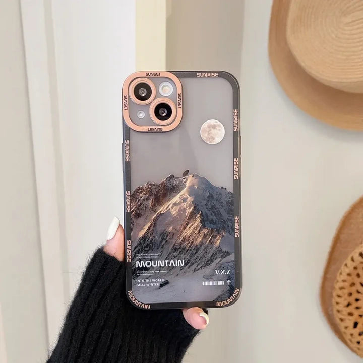 Snow covered mountains iPhone case brown in hand 