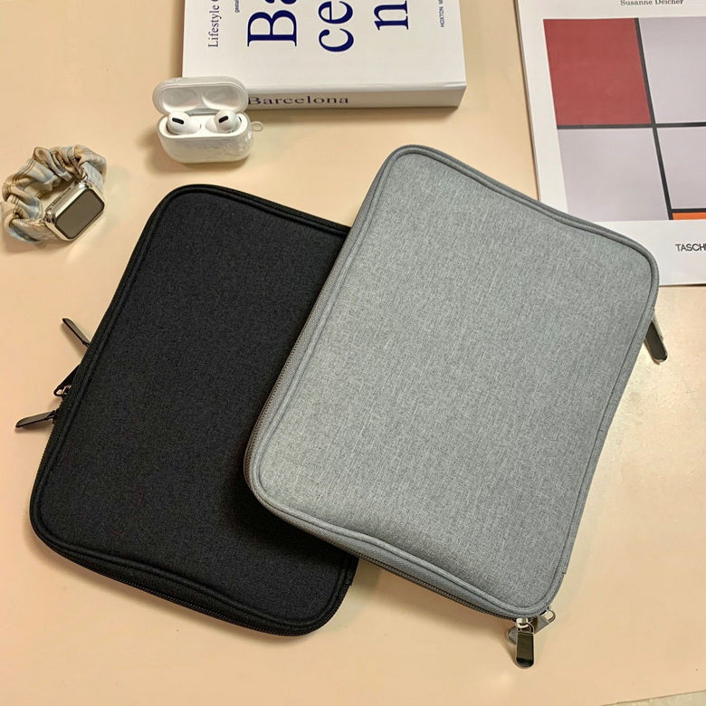 two black and grey organizers for straps and accessories watche airpods book on the table