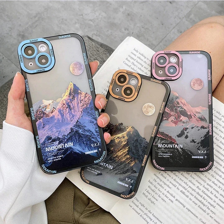 Snow covered mountains three iPhone cases blue brown pink in hand book knees